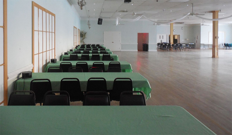 Tables lined up against one side of the Ballroom